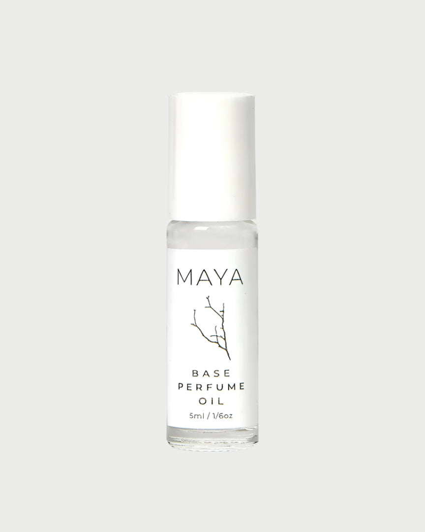 The MAYA Base Mini is a 5ml vegan, cruelty-free roll-on perfume in a clear glass bottle with a white cap and minimalist design—blending luxury and sustainability from MAYA.