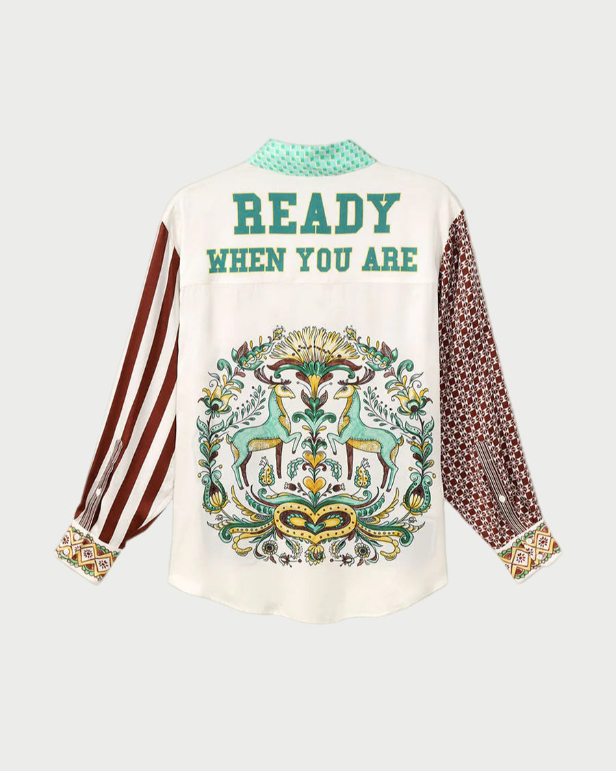 White shirt with decorative design and text on a gray background