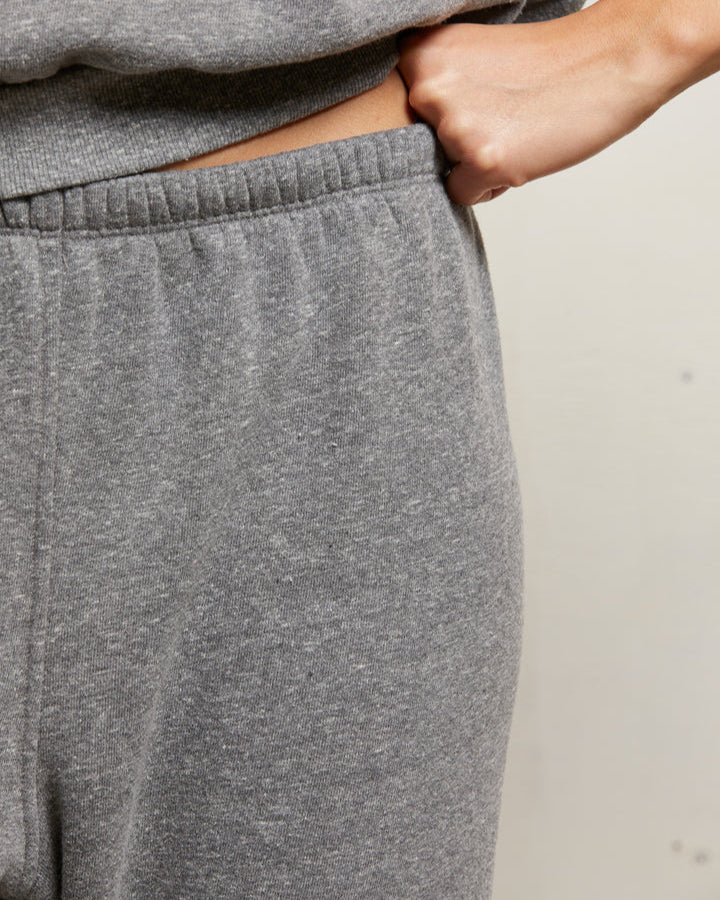 Gray sweatpants worn by a person with a neutral background