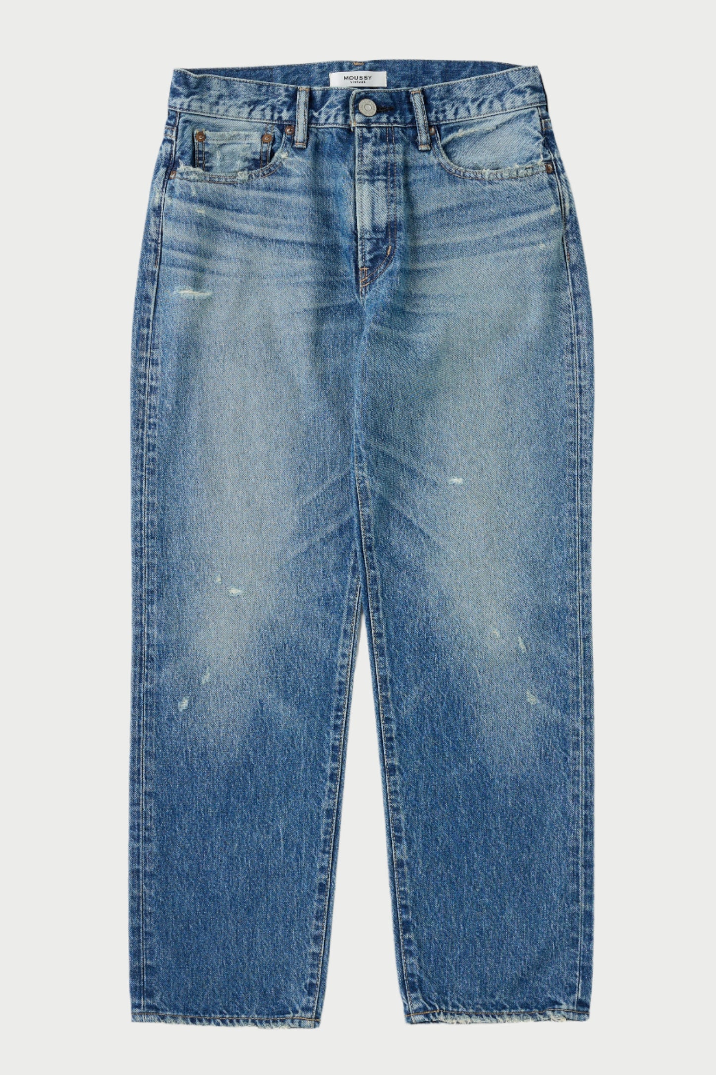 Blue jeans with slight distressing on a white background
