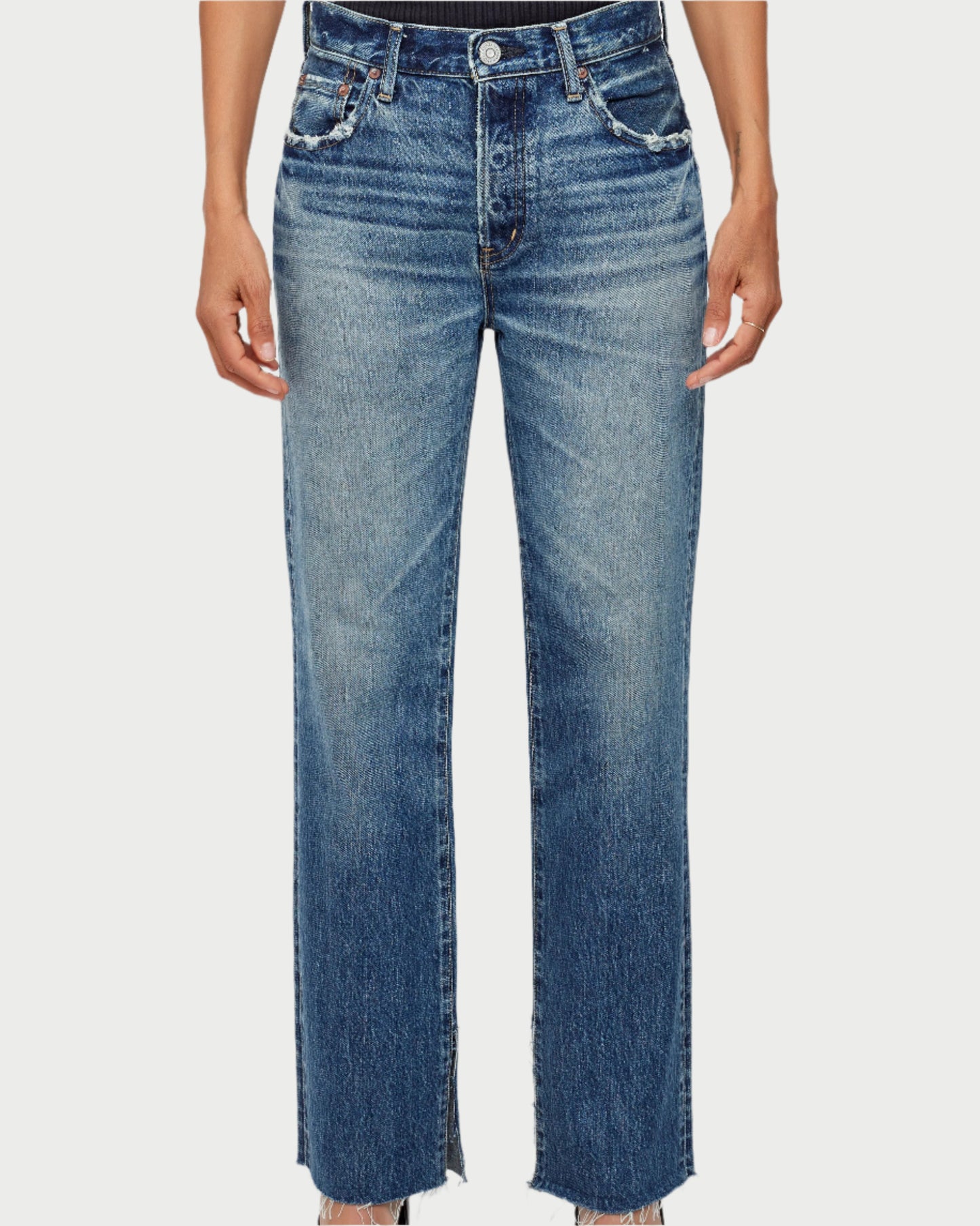 Person wearing blue jeans on a white background