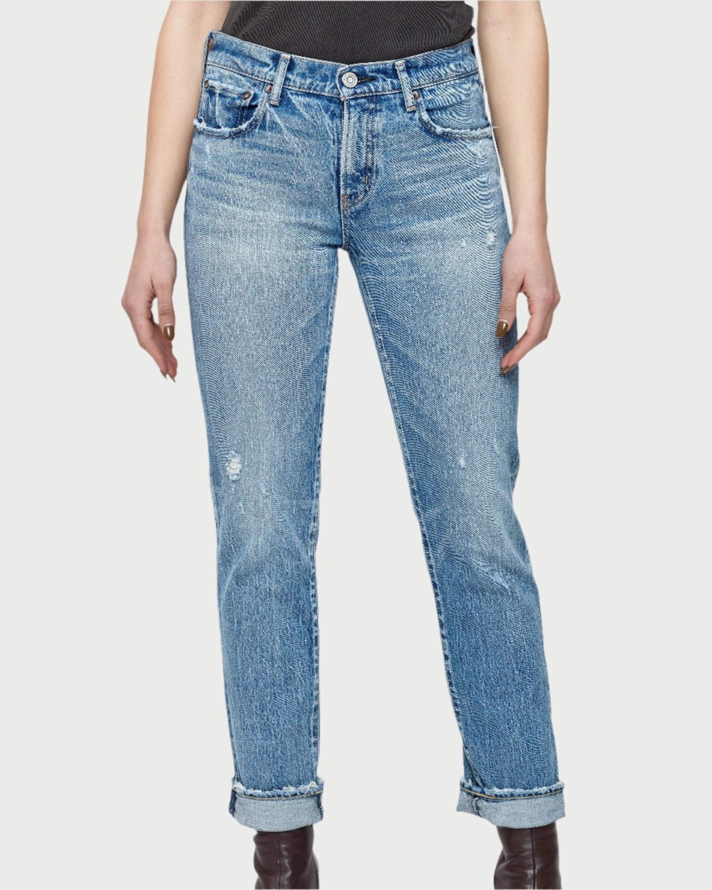 A person models Moussy's light blue Farmingdale Slim Straight Jeans with rolled cuffs, paired with a black top and dark ankle boots, shown from shoulders to feet against a plain background.