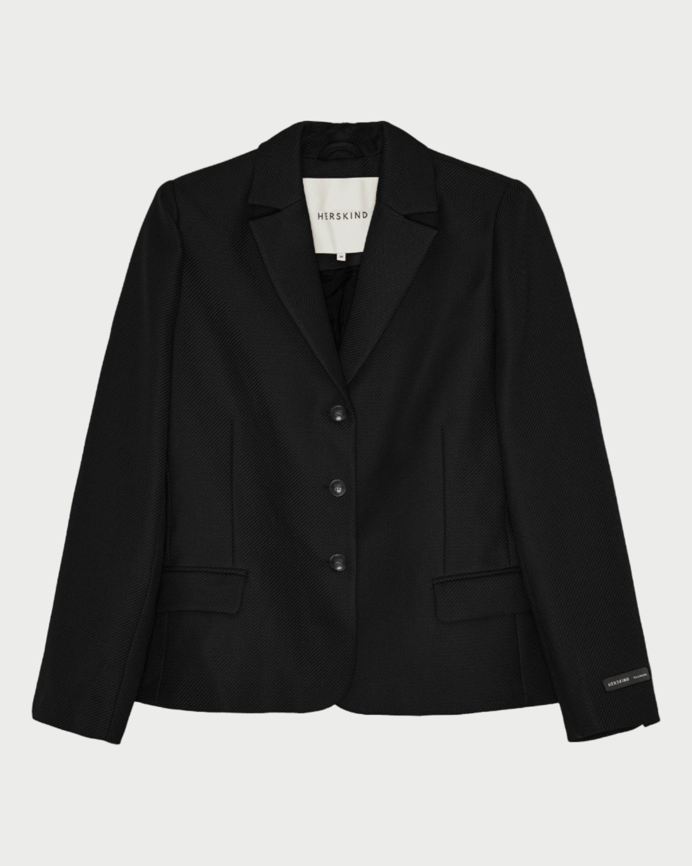 Black blazer on a light gray background