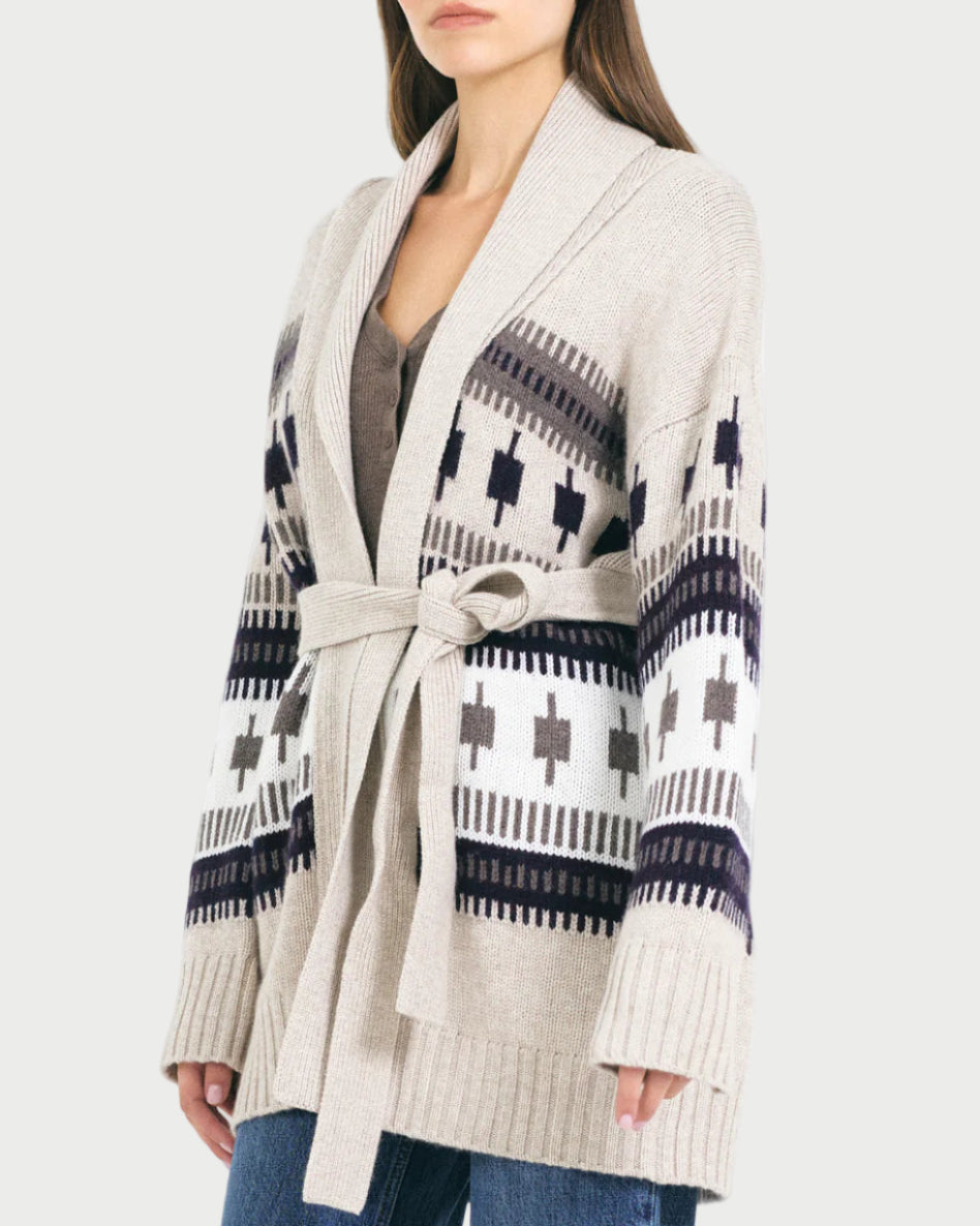 Woman wearing a patterned cardigan on a white background