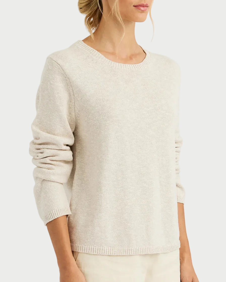 Woman wearing a beige sweater on a white background