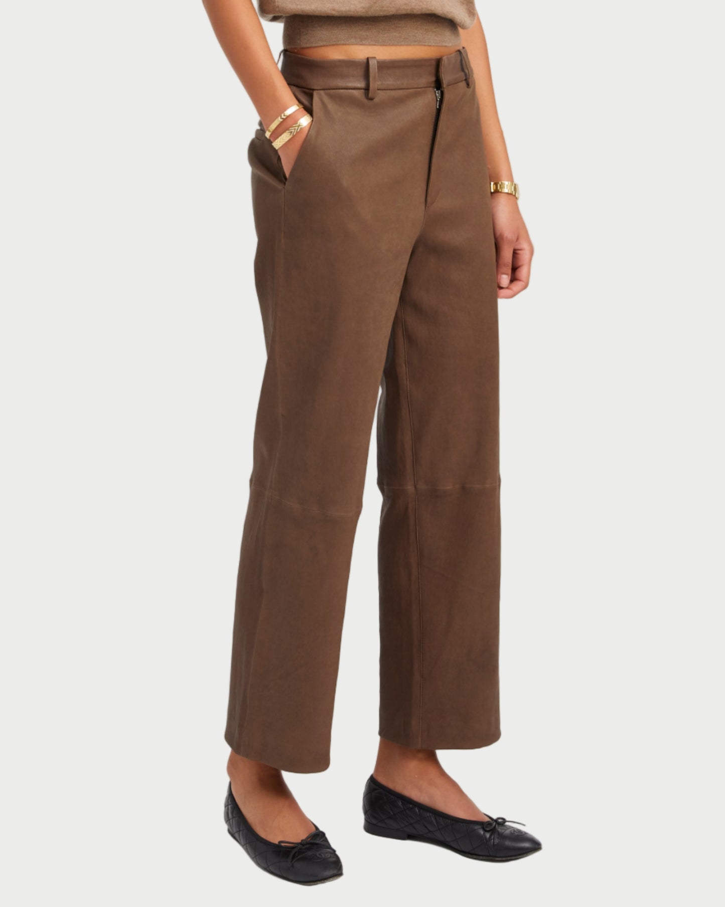 Woman wearing a brown outfit with a plain background