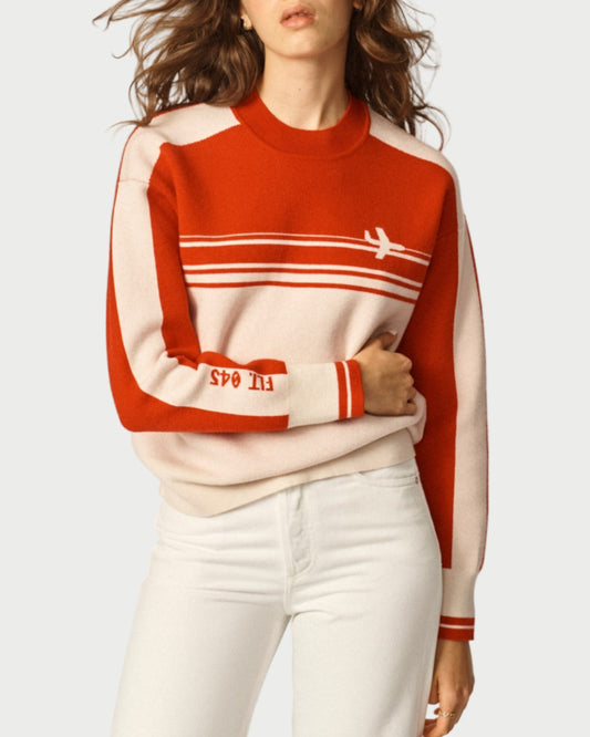Woman wearing a red and white sweater with 'SPO' text on a plain background