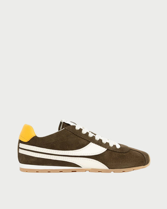 Brown sneaker with white accents and a yellow heel tab on a white background