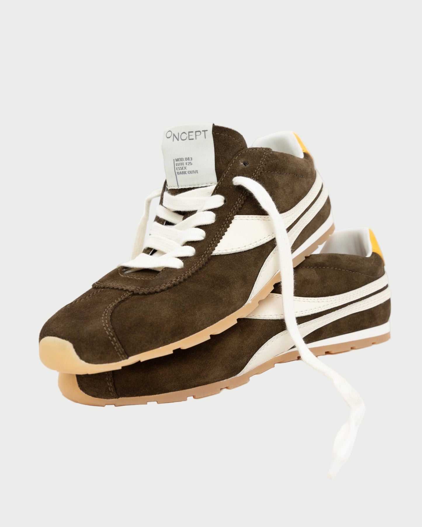 Brown and white sneakers with a visible brand label on a white background