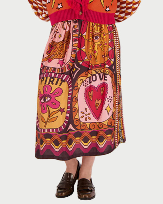 Woman wearing a colorful patterned dress on a white background
