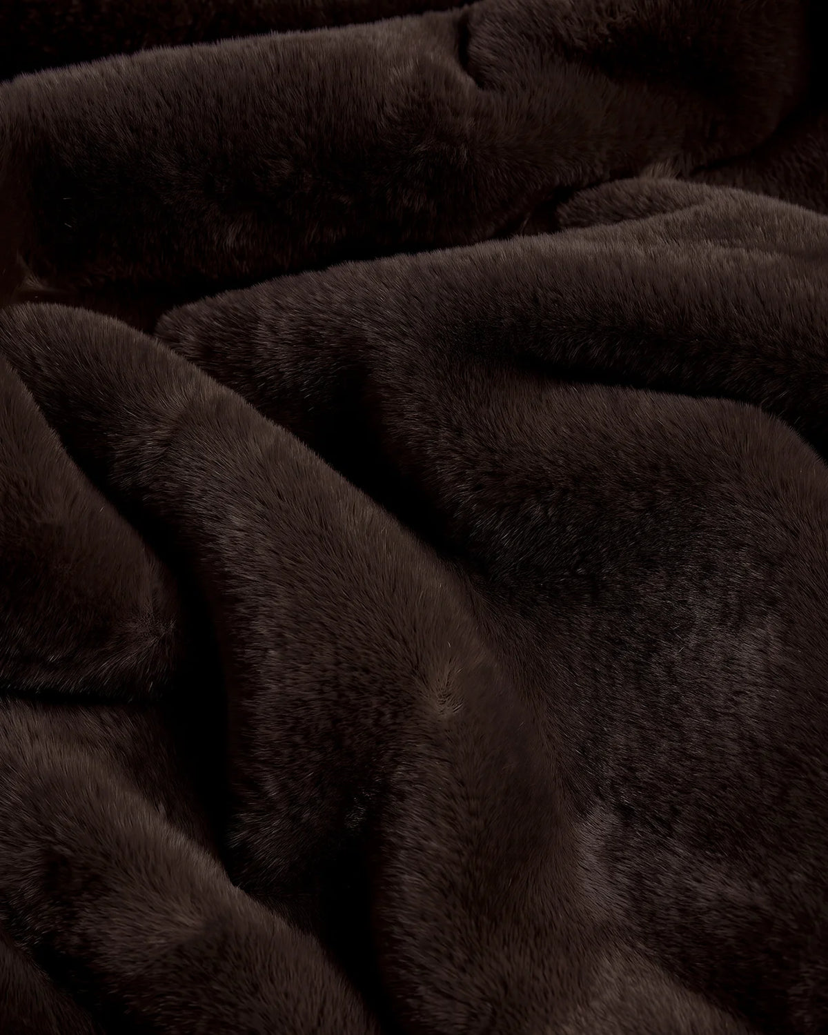 Close-up of a soft, dark brown Apparis Brady Blanket Espresso made of faux fur.
