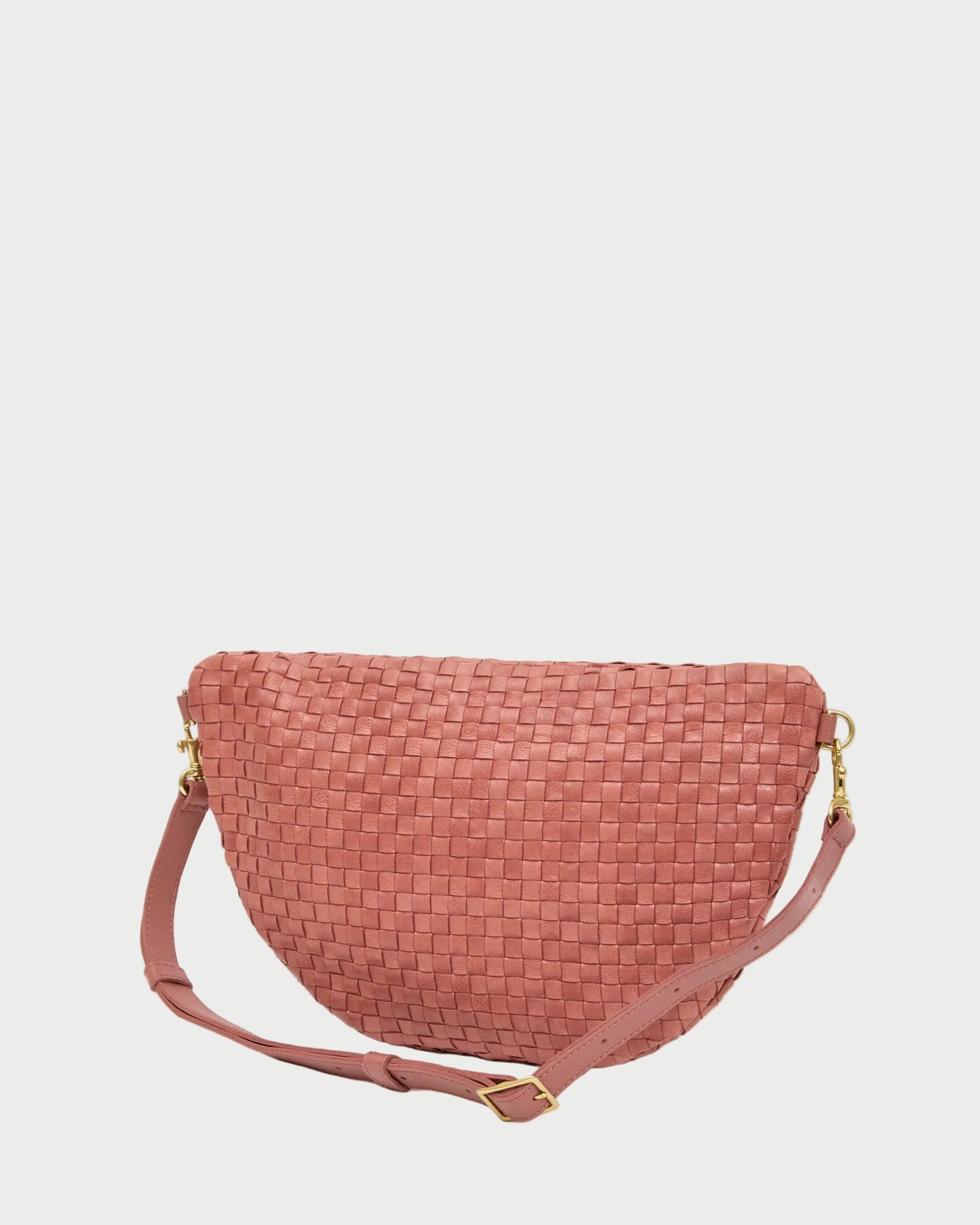 Pink woven handbag on a white background