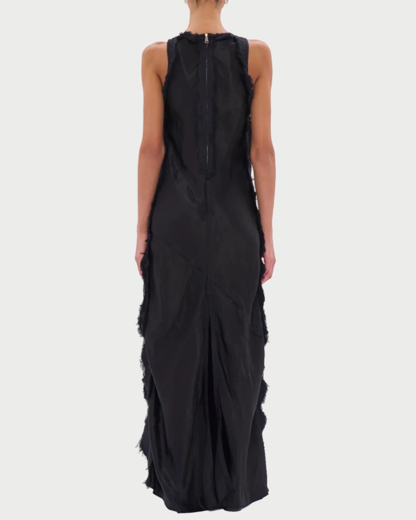 Black sleeveless dress with ruffled details on a white background