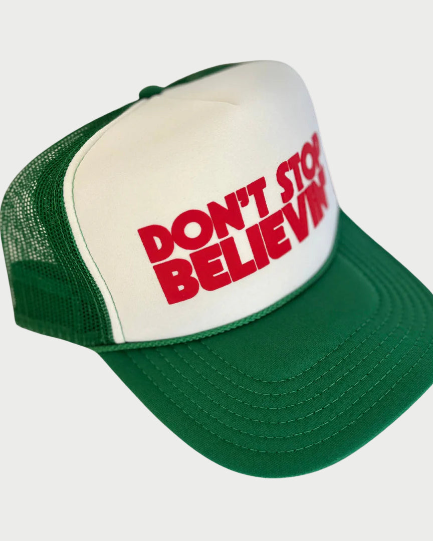 Green and white cap with red text 'DON'T STOP BELIEVING' on a white background