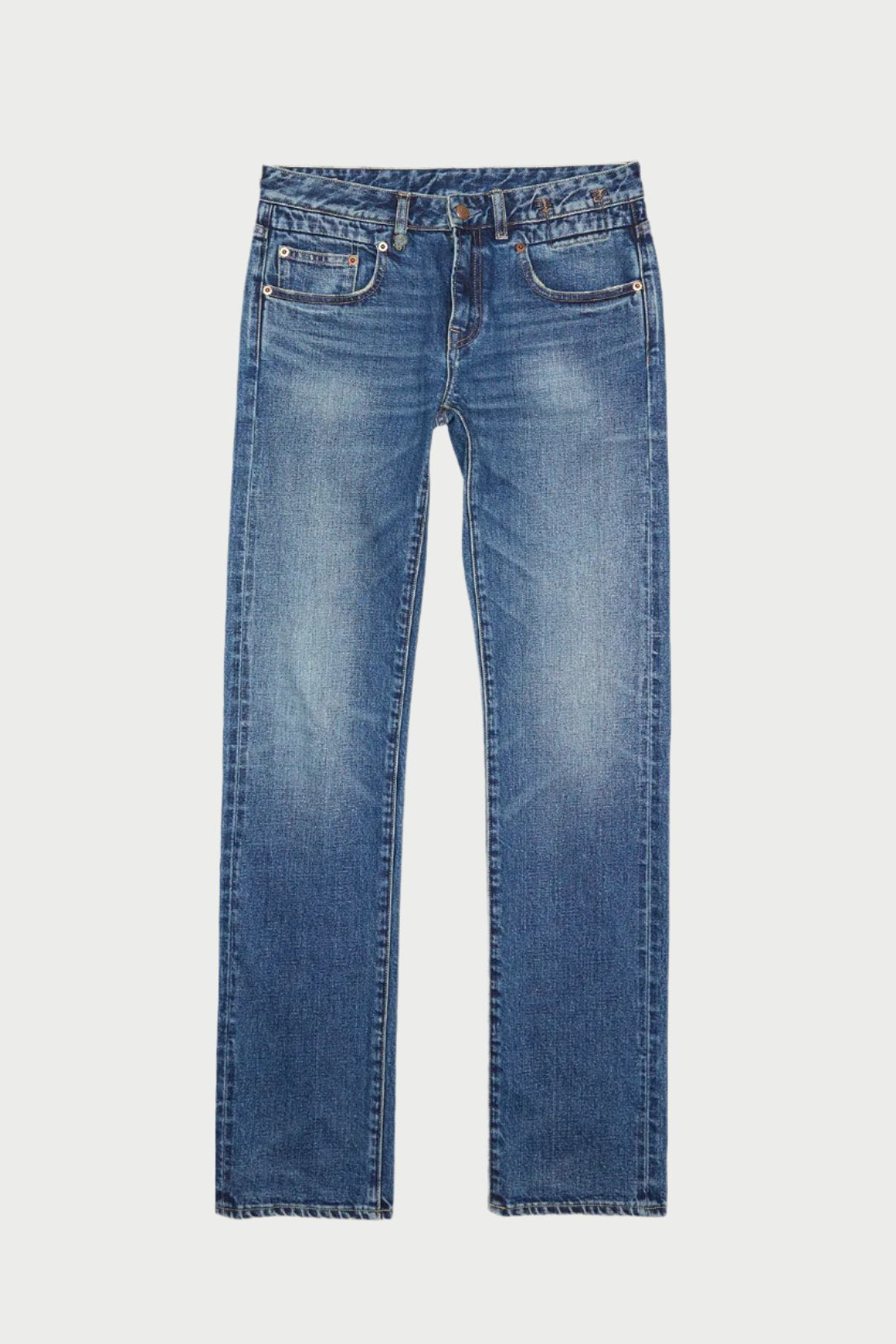 A pair of Tobi Boy Jean with a straight-leg cut is displayed. Made from 100% cotton, these jeans feature a slight faded wash on the thighs and knees, adding a worn-in look. They have a button and zipper closure, belt loops, and five pockets – two in the back, two in the front, and a coin pocket by R13.