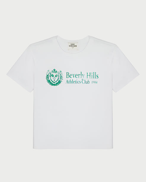 The BH Athletic Club Everyday Tee by Sunny Somewhere is a white, boxy-fit tee with green "Beverly Hills Athletic Club 1984" text and a crest emblem, plus a classic crew neck and short sleeves for a vintage look.