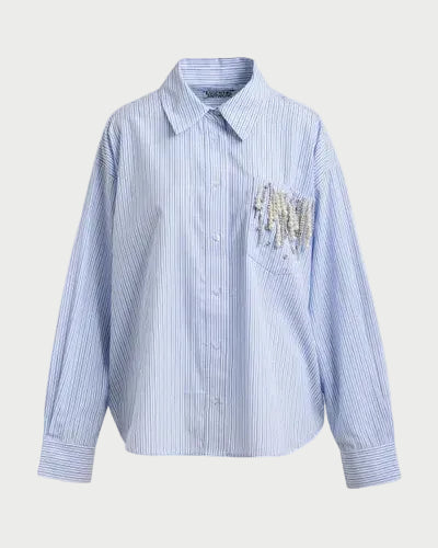 Blue striped shirt with a decorative pocket on a light gray background