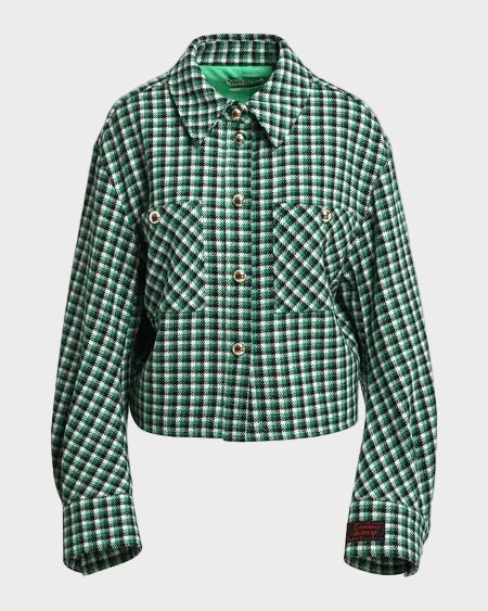 A green and black checkered cropped jacket with a pointed collar, button front, and two chest pockets, displayed on a neutral light gray background.