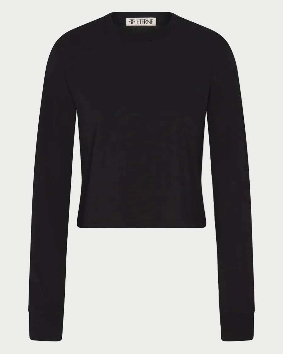 The Éterne Long Sleeve Boxy Tee by Eterne—a plain black, long-sleeve, crew neck sweater made from a cotton-modal blend—is displayed against a white background, with a small label visible at the neckline.