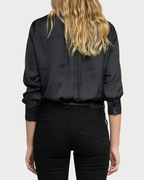 Person wearing a black shirt and black pants on a white background