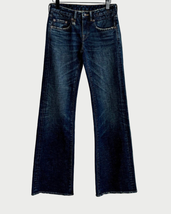 The R13 Boy Flare Jeans by R13, in dark blue slim fit with a subtle flare at the hem, are displayed on a black hanger against a white background.