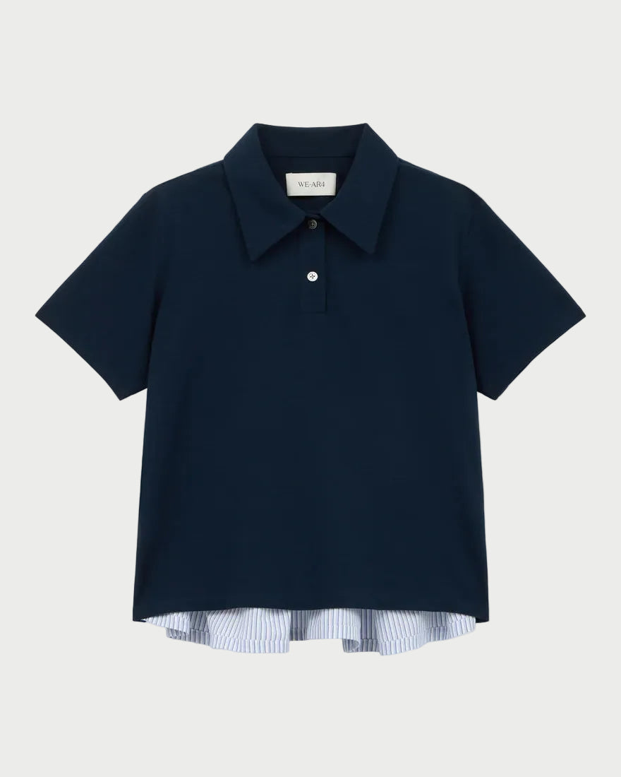 Navy blue polo shirt with a white label on a light gray background