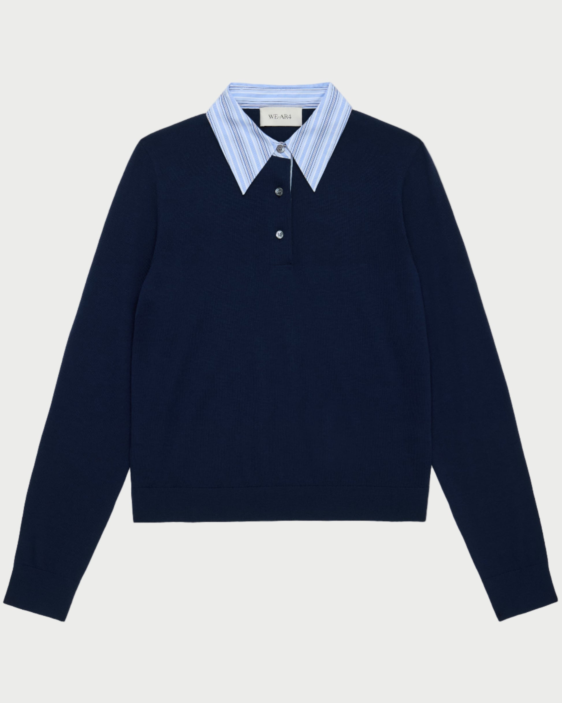 The WE-AR4 Charlie Polo by WE-AR4 is a navy knit pullover with light blue and white striped collar detail and a partial button placket, offering an effortlessly preppy layered look.