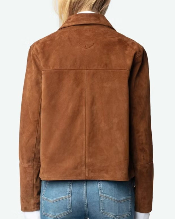 Person wearing a brown suede jacket and blue jeans on a white background