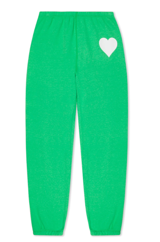 The SPRWMN Heart Sweatpants are bright green women's joggers with an elastic waistband and cuffs, featuring a white heart graphic on the upper left thigh.
