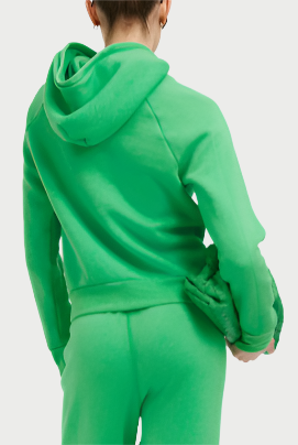 Person wearing a green tracksuit on a white background