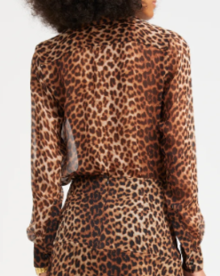 Person wearing a leopard print dress on a white background