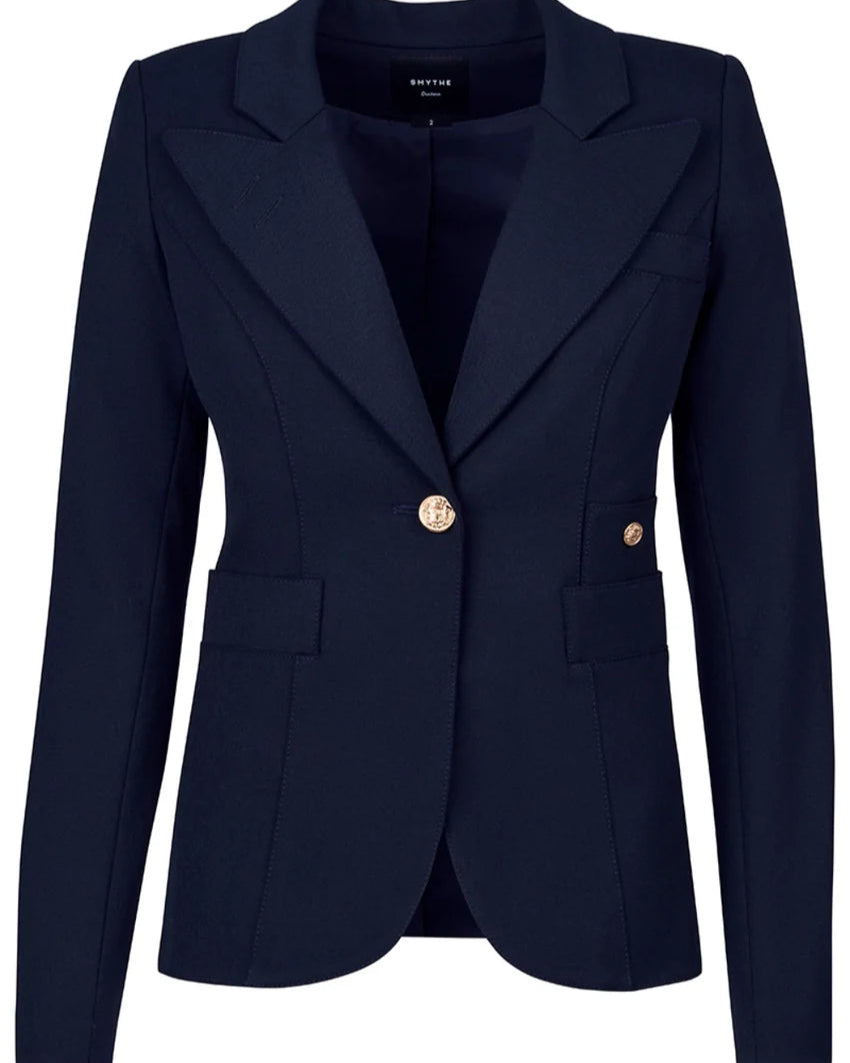 The Smythe Full Back Duchess Blazer is a navy blue tailored jacket with notch lapels, a single gold button closure, and two front flap pockets, shown against a white background.