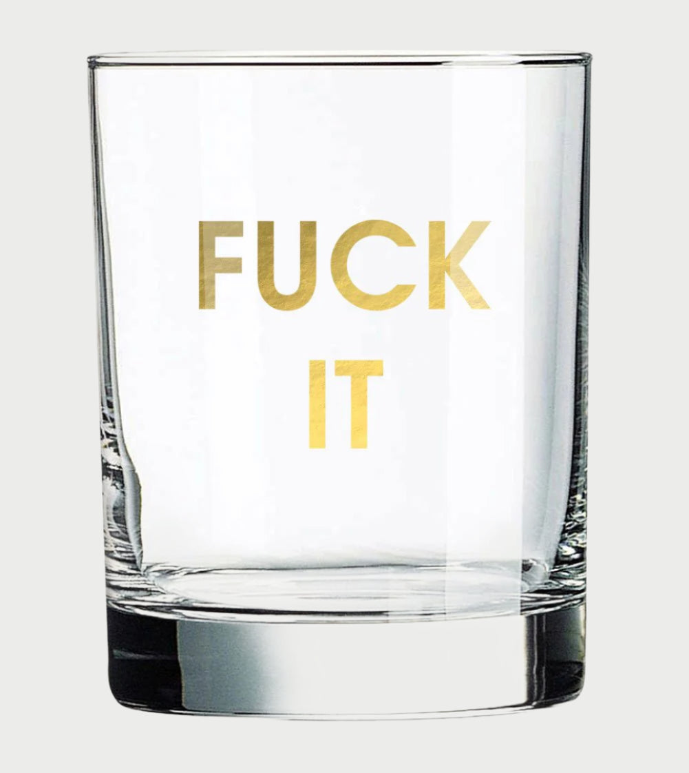 A clear Chez Gagné More Rocks Glass, featuring a bold gold foil "FUCK IT" message, adds a cheeky twist to your drinkware collection.
