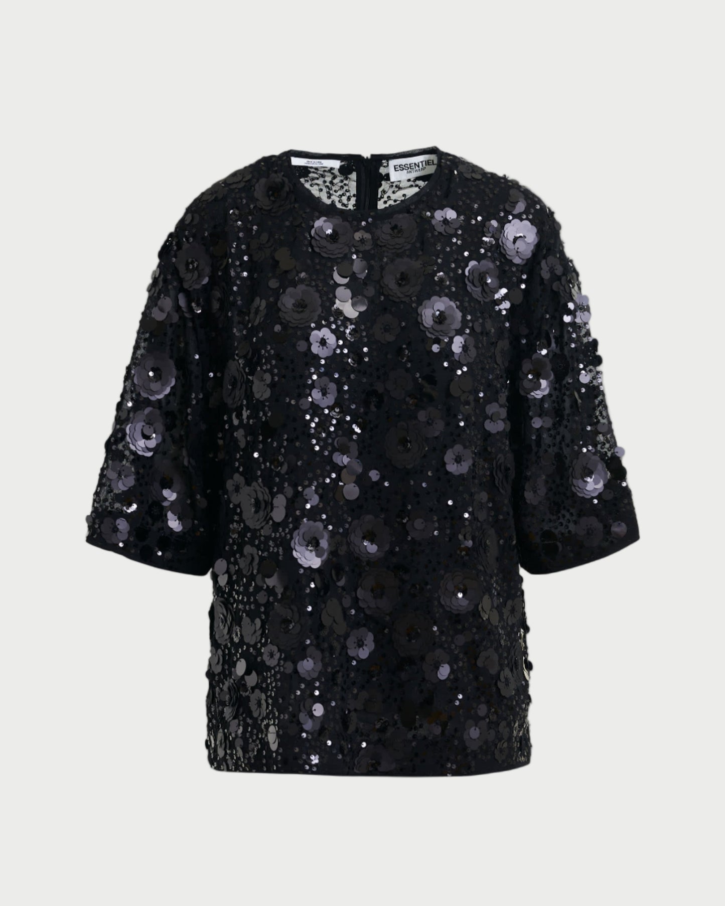 Black sequin dress on a light gray background