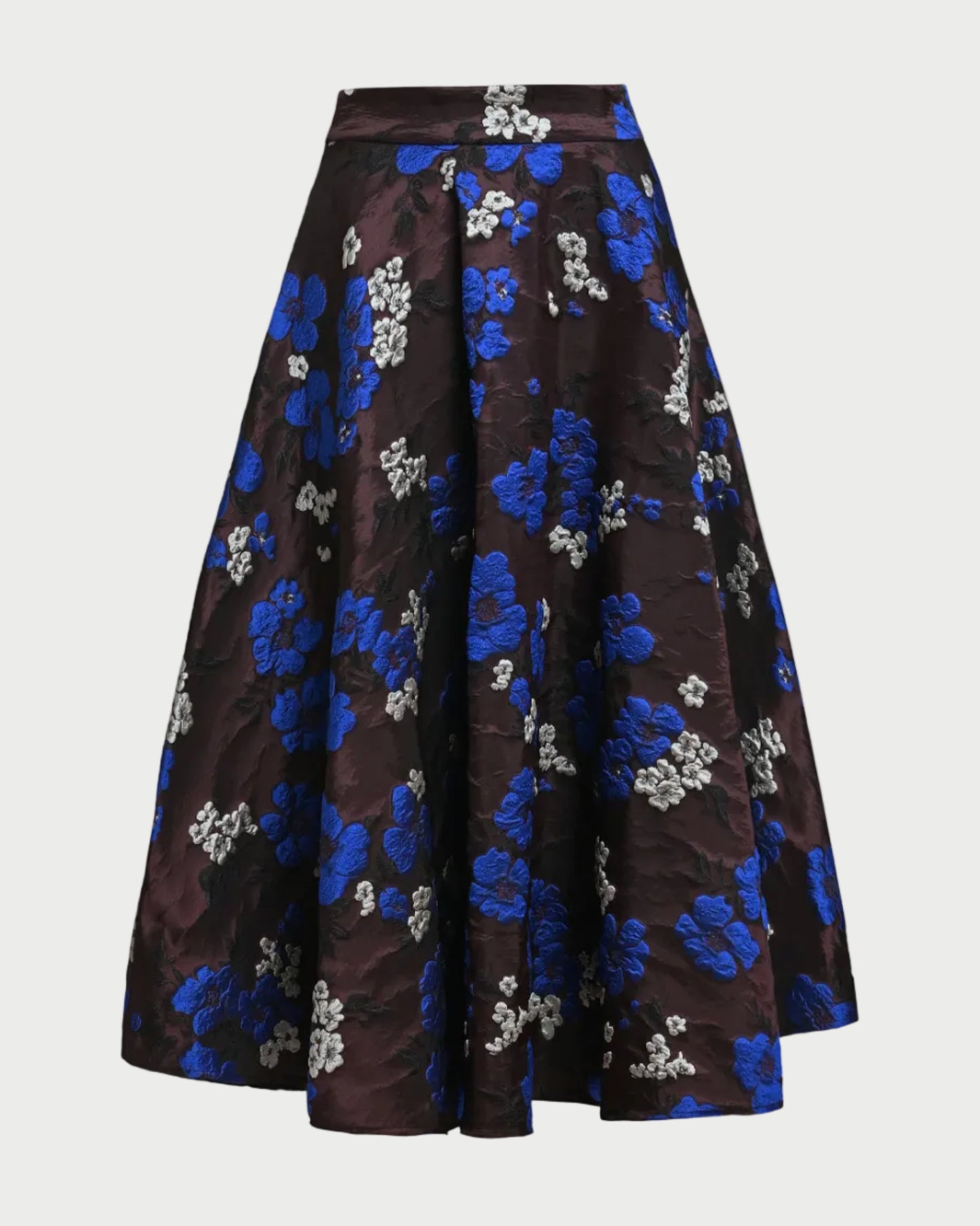 A high-waisted, A-line midi skirt in a dark brown brocade fabric with a vibrant blue and white floral jacquard pattern, shown against a plain light gray background.
