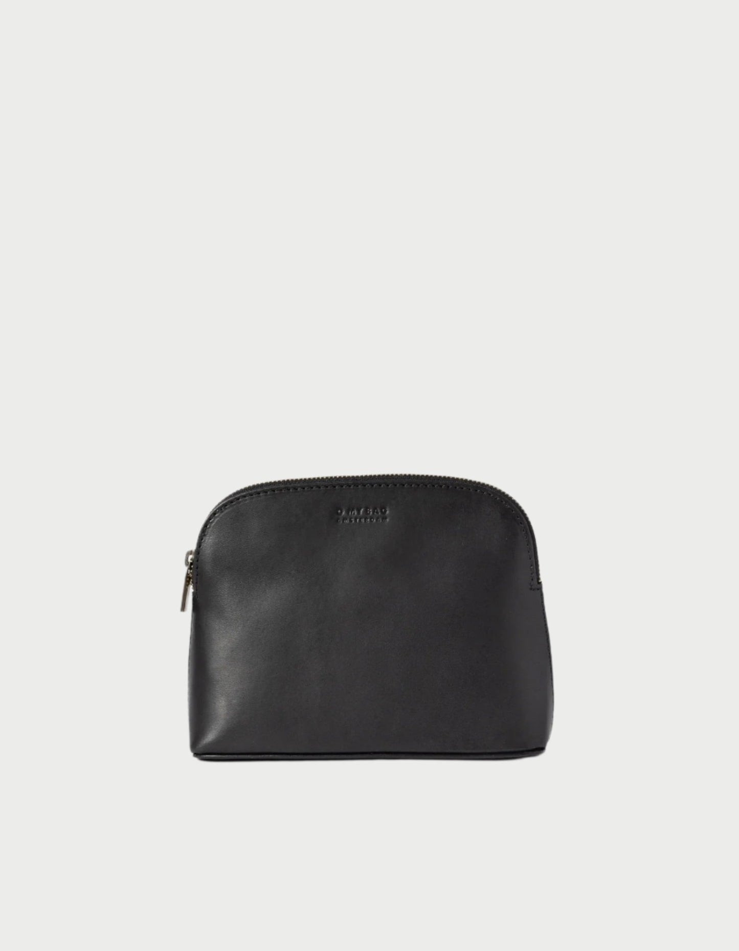 A Cosmetic Bag in Black by O MY BAG stands upright against a light background, representing the essence of a classic leather cosmetic accessory. With its smooth texture, curved top, and small metallic zipper on the side, it makes an ideal gift for stylishly organizing travel-sized toiletries.