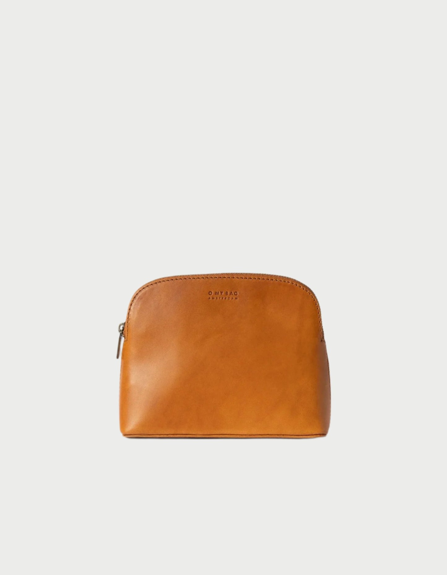 Introducing the Cosmetic Bag in Cognac by O MY BAG, a chic accessory ideal for carrying travel-sized toiletries. This light brown leather pouch features a zipper closure and is showcased against a plain white background, highlighting its subtle stitching and branding on the front.
