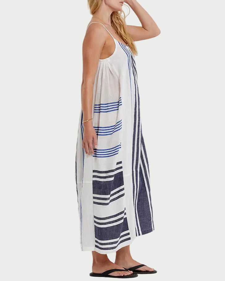 Woman wearing a white dress with blue stripes on a white background