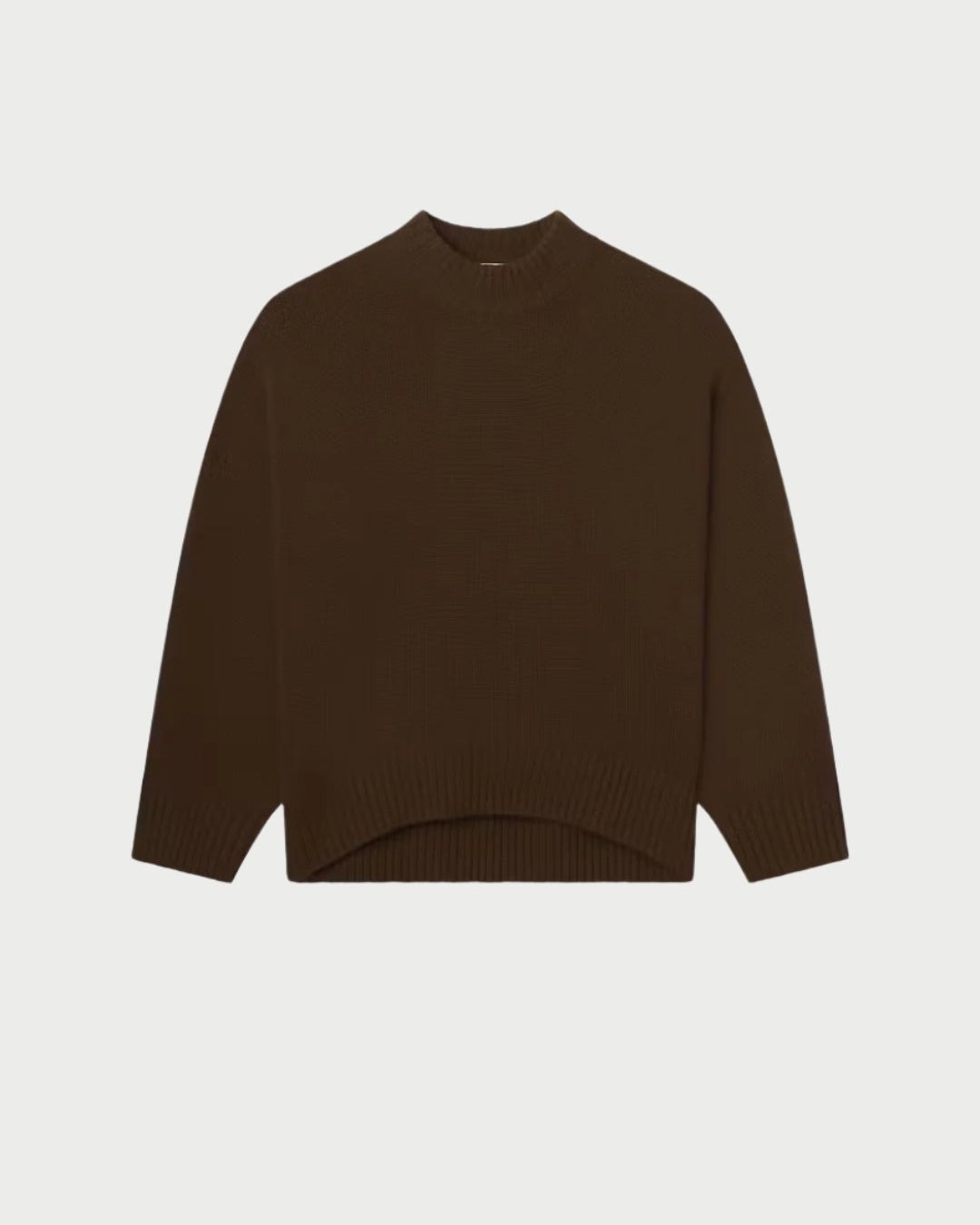 The Frame Oversized Cashmere Crew Sweater features a round neckline, long sleeves, ribbed cuffs and hem, set against a plain white background. This sweater promises pure comfort with its simple and cozy design.