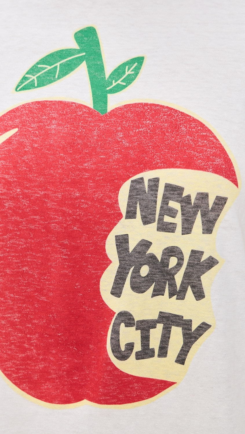 The RE/DONE NYC Big Apple Tee features a red apple with a green stem and leaf, partly eaten to reveal "NEW YORK CITY" in bold black letters—ideal for any vintage New York graphic tee lover.
