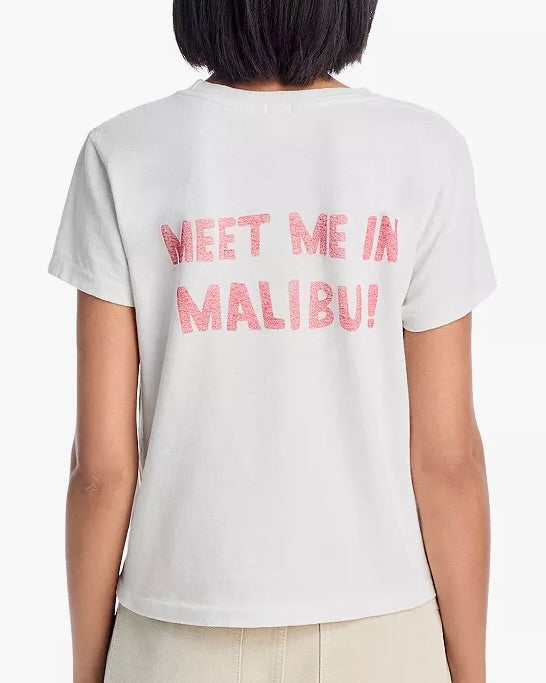 A person wearing a RE/DONE Surf's Up Snoopy Tee, made from 100% cotton with pink "MEET ME IN MALIBU!" text on the back, shown from behind.