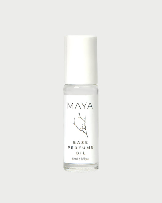 The MAYA Base Mini is a 5ml vegan, cruelty-free roll-on perfume in a clear glass bottle with a white cap and minimalist design—blending luxury and sustainability from MAYA.