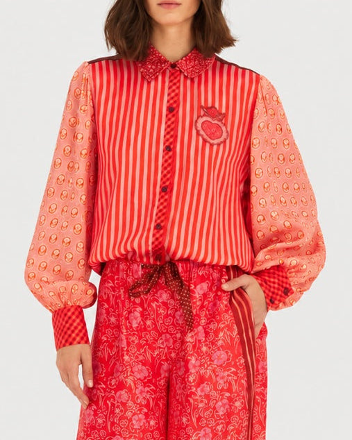 ME369 Sola Puff Sleeve Blouse Red Aura featuring red vertical stripes, red-toned patterned balloon sleeves, a collar, and an embroidered heart emblem on the chest.