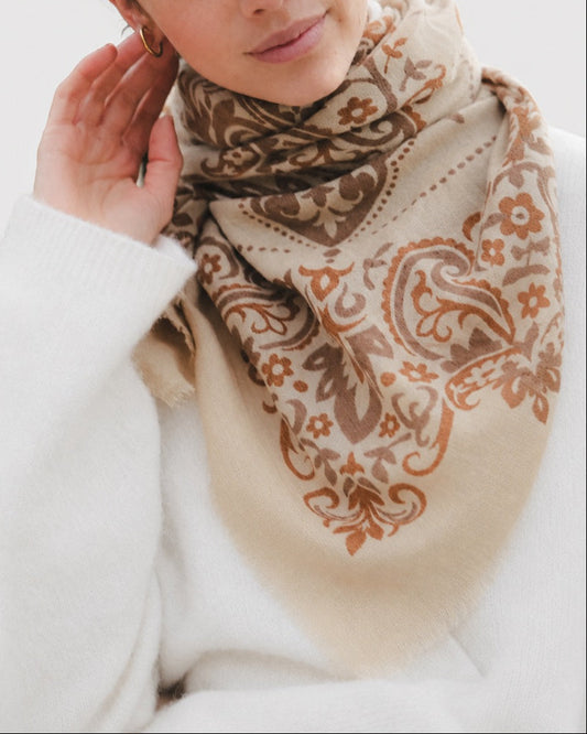 Maison Lecomte Flament Cashew bandana scarf worn with a cream sweater.