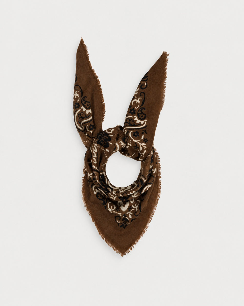 Maison Lecomte Flament Hazelnut bandana scarf tied in a knot, showing its brown and ivory print.