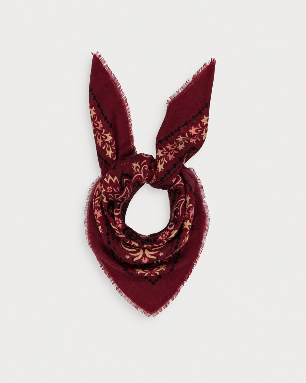 Maison Lecomte Flament Salem scarf tied in a knot, showing its burgundy bandana print.
