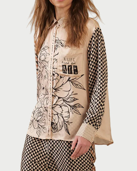 Woman wearing a patterned outfit with a neutral background