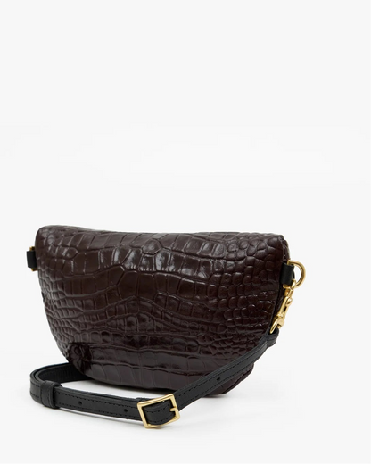 Clare V. Petite Fanny Mahogany crescent-shaped crossbody bag in dark brown croco-embossed leather, featuring a black strap and gold-tone hardware.