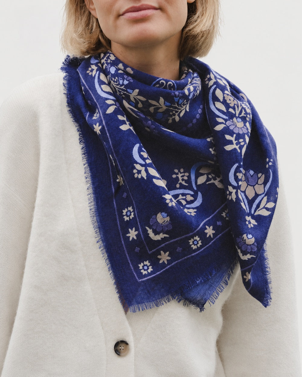 Maison Lecomte Flament Secret Garden Dark Navy scarf worn with a cream cardigan.