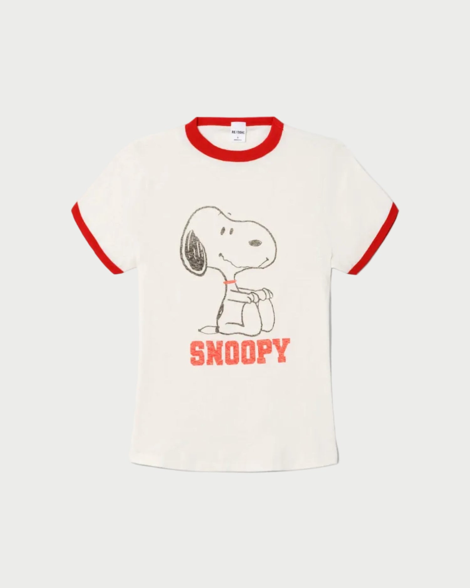The RE/DONE Snoopy 60s Slim Ringer Tee is a vintage-style white t-shirt with red trim, featuring a Snoopy graphic and bold red “SNOOPY” lettering below the illustration.